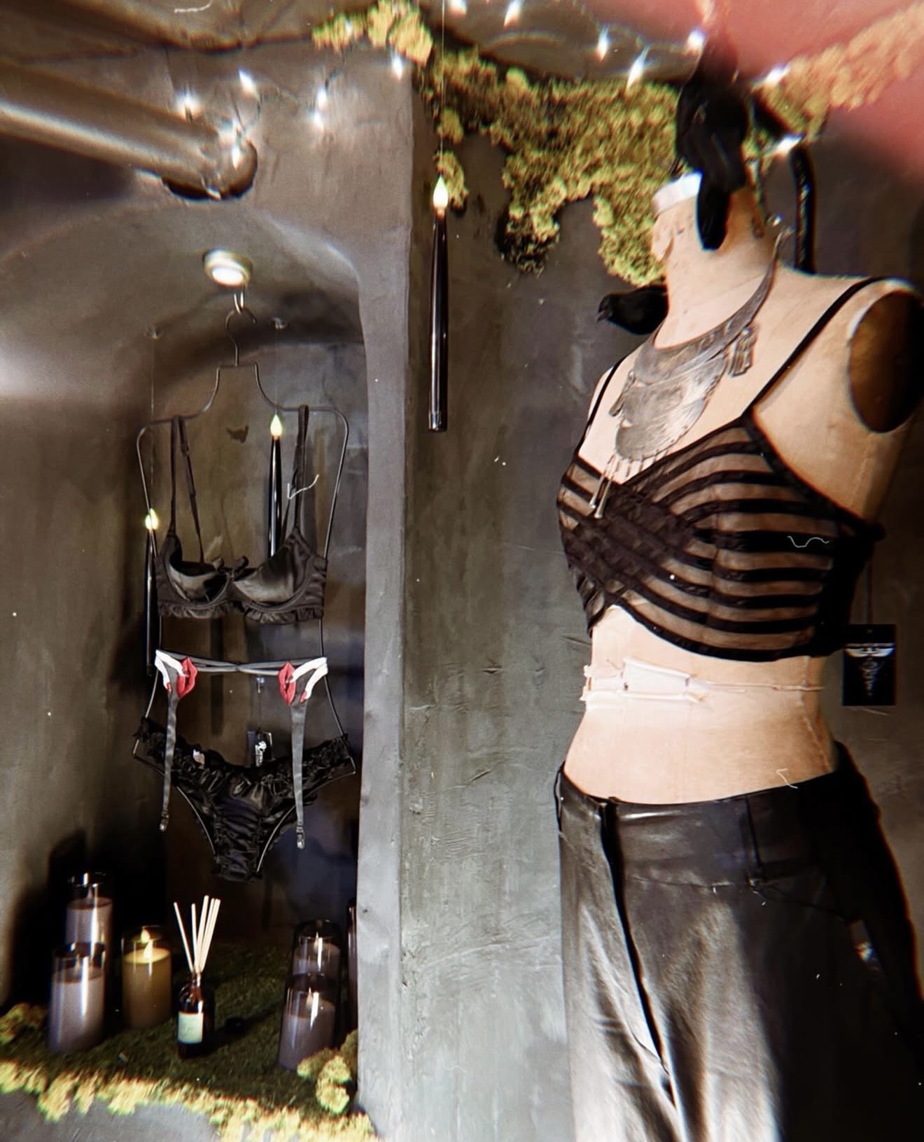 A vintage mannequin in a sheer striped top and leather skirt inside Hidden Gem Hudson